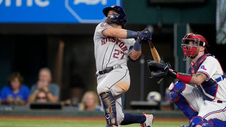 Houston Astros' Jose Altuve, left, follows through on a solo home run as Texas Rangers catcher Jonah Heim, right, looks on in the sixth inning of a baseball game, Monday, Sept. 4, 2023, in Arlington, Texas. (Tony Gutierrez/AP)