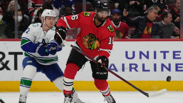 Jujhar Khaira, right, controls the puck past Vancouver Canucks left wing Anthony Beauvillier during the first period of an NHL hockey game in Chicago, Sunday, March 26, 2023. (Nam Y. Huh/AP)