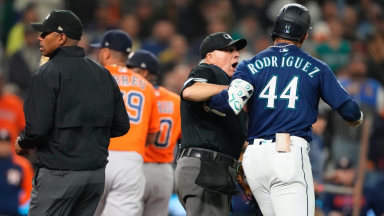 Seattle Mariners' Julio Rodriguez (44) is held back by an umpire after he exchanged words with Houston Astros relief pitcher Hector Neris following a strikeout in a baseball game Wednesday, Sept. 27, 2023, in Seattle. The Astros won 8-3. (Lindsey Wasson/AP)