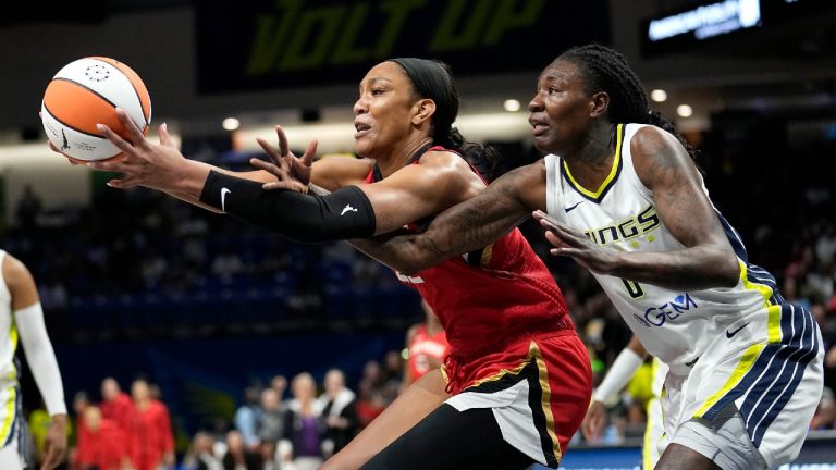 Las Vegas Aces forward A'ja Wilson, left, and Dallas Wings forward Natasha Howard, right, compete for control of a rebound during the first half of a WNBA basketball game Tuesday, Aug. 8, 2023, in Arlington, Texas. (Tony Gutierrez/AP)