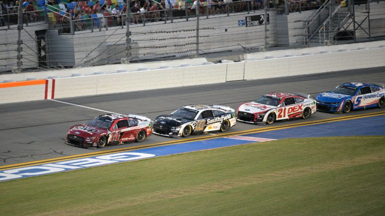 Chase Briscoe (14), Aric Almirola (10), Harrison Burton (21) and Kyle Larson (5) lead a pack through the front stretch during a NASCAR Cup Series auto race at Daytona International Speedway, Saturday, Aug. 26, 2023, in Daytona Beach, Fla. (Phelan M. Ebenhack/AP)