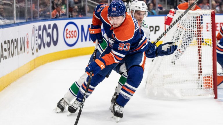 Vancouver Canucks' Teddy Blueger (53) chases Edmonton Oilers' Ryan Nugent-Hopkins (93) during first period NHL pre season action in Edmonton, Wednesday, Sept. 27, 2023. (Jason Franson/CP)