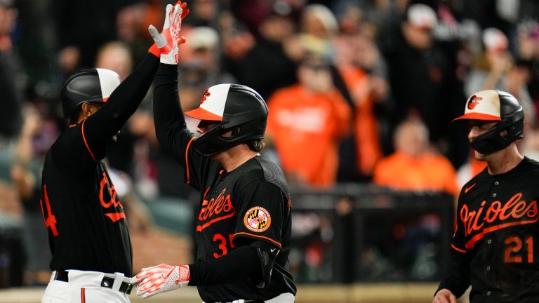 Baltimore Orioles' Adley Rutschman, center, is greeted near the dugout by Aaron Hicks, left, after hitting a two-run home run off Washington Nationals starting pitcher Patrick Corbin during the third inning of a baseball game, Wednesday, Sept. 27, 2023, in Baltimore. Orioles' Austin Hays, right, scored on the home run. (Julio Cortez/AP)