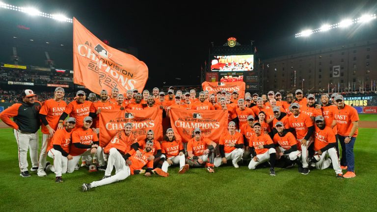 Baltimore Orioles players pose for photographers after defeating the Boston Red Sox 2-0 in a baseball game to win the AL East championship Thursday, Sept. 28, 2023, in Baltimore. (Julio Cortez/AP)