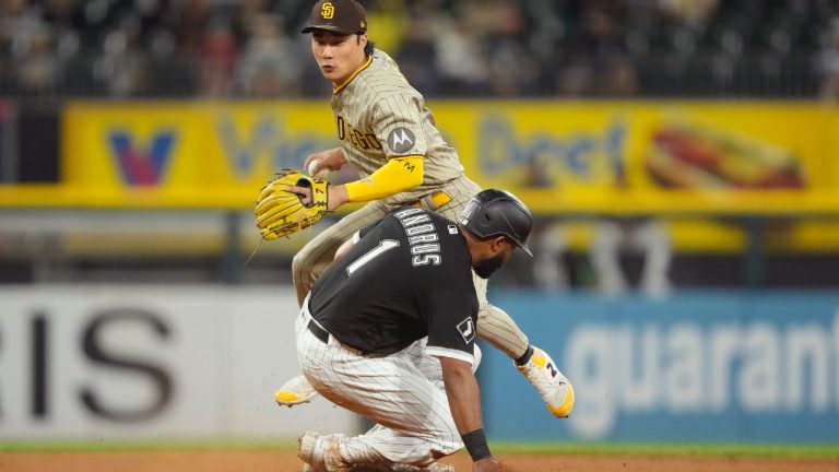 San Diego Padres second baseman Ha-Seong Kim, top, looks to first after forcing Chicago White Sox's Elvis Andrus, bottom, out at second during the seventh inning of a baseball game Friday, Sept. 29, 2023, in Chicago. (Charles Rex Arbogast/AP)