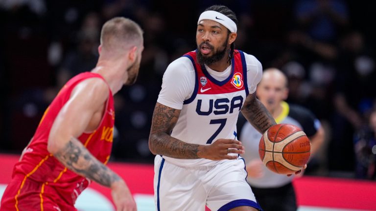 U.S. forward Brandon Ingram (7) bings the ball up court agasint Montenegro forward Nemanja Radovic (11) during the second half of a Basketball World Cup second round match in Manila, Philippines Friday, Sept. 1, 2023. United States defeated Montenegro 85-73. (Michael Conroy/AP)