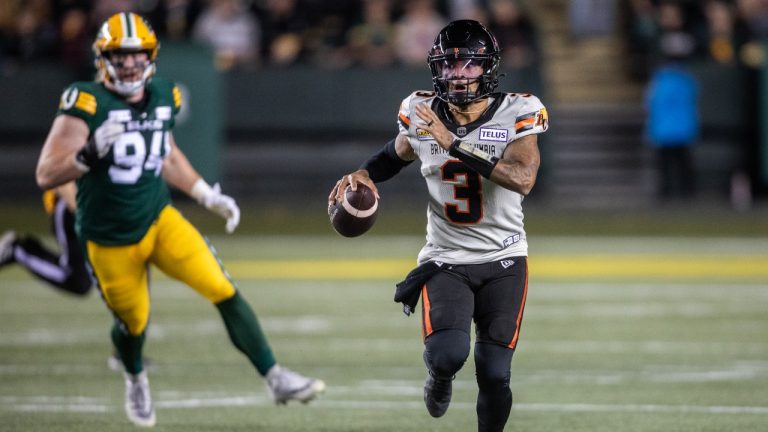 B.C. Lions quarterback Vernon Adams Jr. (3) runs the ball as Edmonton Elks' Jake Ceresna (94) looks on during first half CFL action in Edmonton on Friday, September 22, 2023. (Amber Bracken/THE CANADIAN PRESS)