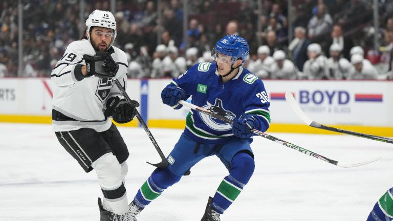 Vancouver Canucks' Akito Hirose (36) and Los Angeles Kings' Alex Iafallo (19) skate during first period NHL hockey action in Vancouver on Sunday, April 2, 2023. (Darryl Dyck/CP)