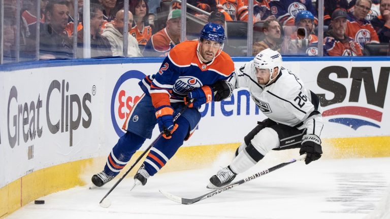 Los Angeles Kings' Sean Walker (26) and Edmonton Oilers' Evan Bouchard (2) battle for the puck during second period NHL Stanley Cup first round playoff action in Edmonton on Tuesday April 25, 2023. (Jason Franson/CP)