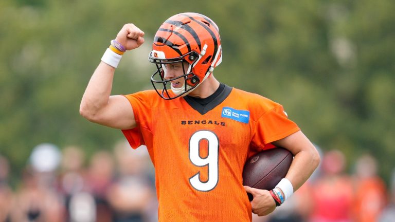 Cincinnati Bengals quarterback Joe Burrow (9) gestures to the crowd during the NFL football team's training camp, Thursday, July 27, 2023, in Cincinnati. (Jeff Dean/AP)