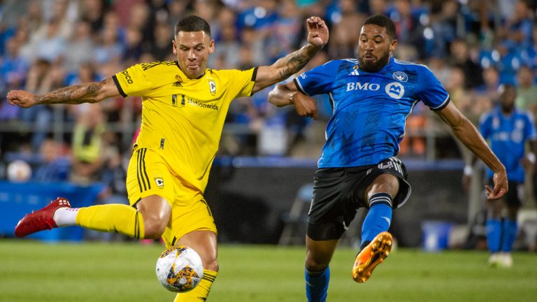 Columbus Crew's Christian Ramirez kicks the ball as CF Montreal's George Campbell defends during first half MLS soccer action in Montreal on Saturday, September 2, 2023. (Peter McCabe/CP)