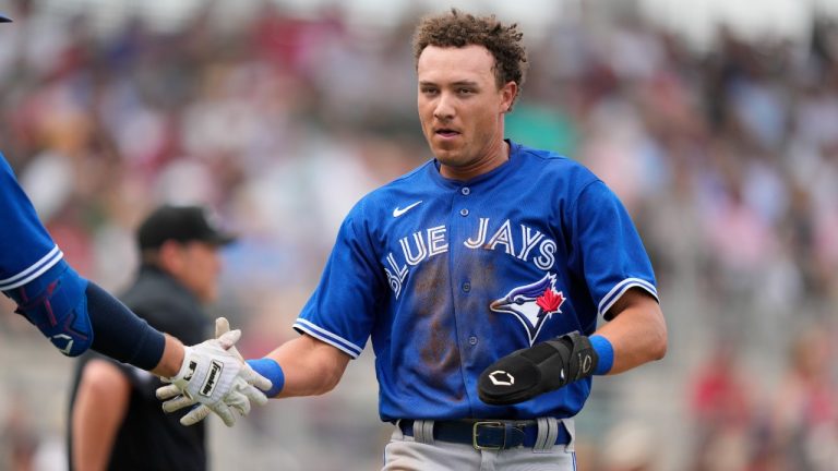 Toronto Blue Jays Cam Eden is greeted after scoring on an RBI double by Rainer Nunez in the fourth inning of a spring training baseball game against the Boston Red Sox in Fort Myers, Fla., Friday, March 10, 2023. (Gerald Herbert/AP)