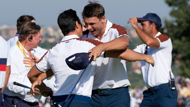 Europe's Viktor Hovland, left and Europe's Ludvig Aberg hug on the 11th green after defeating the United States pair of Scottie Scheffler and Brooks Koepka 9&7, during their morning Foursomes match at the Ryder Cup golf tournament at the Marco Simone Golf Club in Guidonia Montecelio, Italy. (Gregorio Borgia/AP)