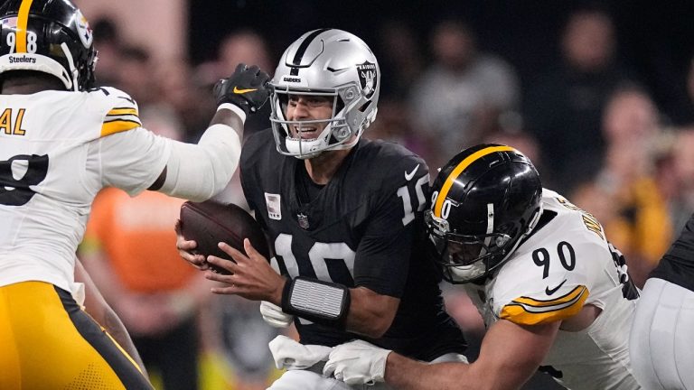 Las Vegas Raiders quarterback Jimmy Garoppolo, center, is sacked by Pittsburgh Steelers linebacker T.J. Watt, right, as defensive end DeMarvin Leal runs in during an NFL football game Sunday, Sept. 24, 2023, in Las Vegas. (Mark J. Terrill/AP Photo)