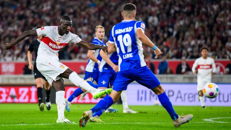 Stuttgart's Serhou Guirassy, left, scores the goal to make it 2:1 during the German Bundesliga soccer match between Darmstadt 98 and VfB Stuttgart in Stuttgart, Germany, Friday Sept. 22, 2023. (Tom Weller/dpa via AP)