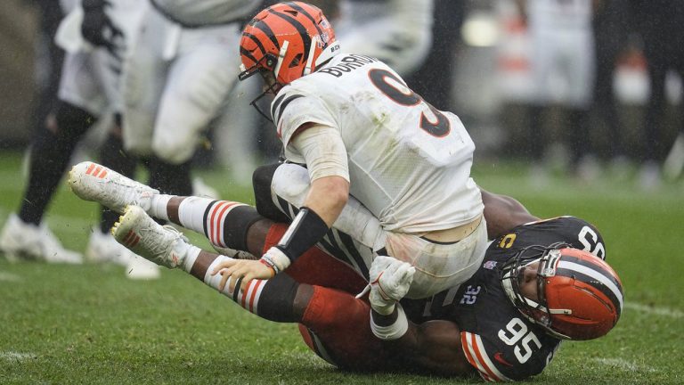 Cincinnati Bengals quarterback Joe Burrow (9) is sacked by Cleveland Browns defensive end Myles Garrett (95) during the second half of an NFL football game. (Sue Ogrocki/AP)
