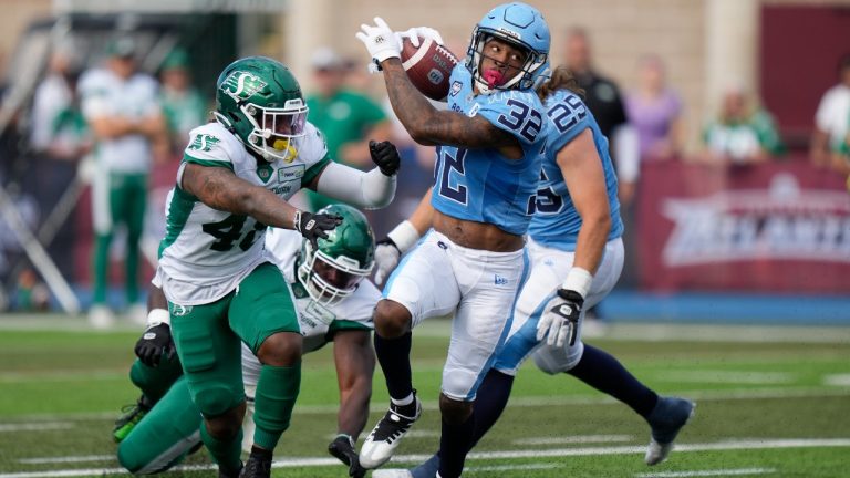 Toronto ArgonautsÕ Javon Leake, right, breaks a tackle before running into the end zone for a touchdown during the first half of CFL action against the Saskatchewan Roughriders in Halifax on Saturday, July 29, 2023. (Darren Calabrese/THE CANADIAN PRESS)