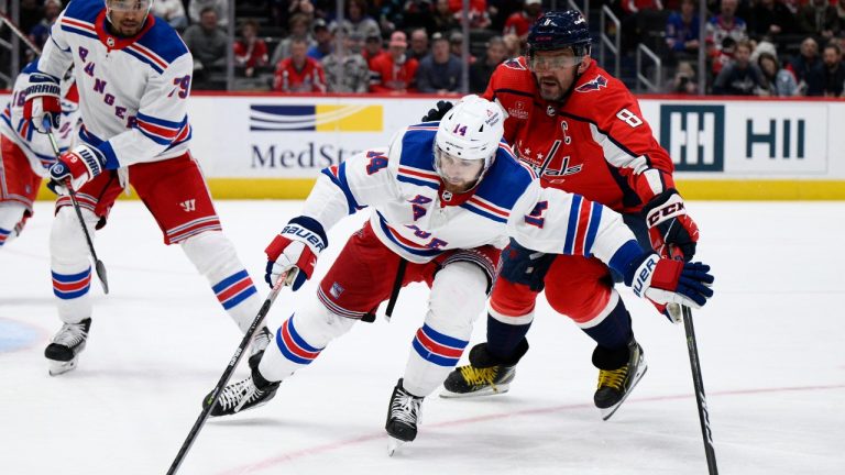 New York Rangers center Tyler Motte (14) reaches for the puck in front of Washington Capitals left wing Alex Ovechkin (8) during the second period of an NHL hockey game, Sunday, April 2, 2023, in Washington. (Nick Wass/AP)