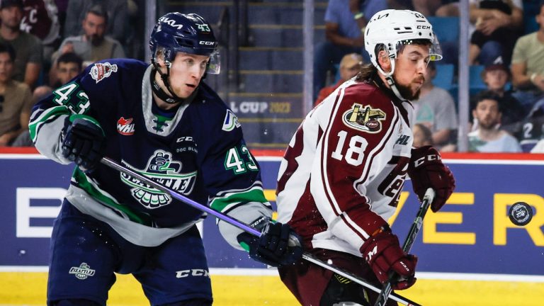 Peterborough Petes forward Connor Lockhart, right, tries for a rebound while Seattle Thunderbirds defenceman Sawyer Mynio, left, looks on during second period semifinal CHL Memorial Cup hockey action in Kamloops, B.C., Friday, June 2, 2023. (Jeff McIntosh/CP)