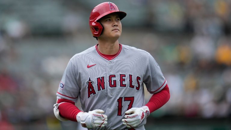 Los Angeles Angels' Shohei Ohtani jogs to the dugout during the seventh inning of a baseball game against the Oakland Athletics. (Jeff Chiu/AP)