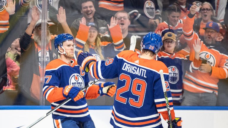 Edmonton Oilers' Connor McDavid (97) and Leon Draisaitl (29) celebrate an overtime goal against the Vancouver Canucks during overtime NHL pre season action in Edmonton, Wednesday, Sept. 27, 2023. (Jason Franson/CP)