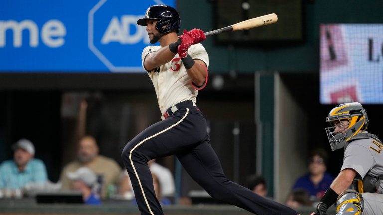 Texas Rangers' Leody Taveras follows through on a run-scoring single as Oakland Athletics catcher Shea Langeliers looks on in the sixth inning of a baseball game, Saturday, Sept. 9, 2023, in Arlington, Texas. Mitch Garver scored on the hit. (Tony Gutierrez/AP)