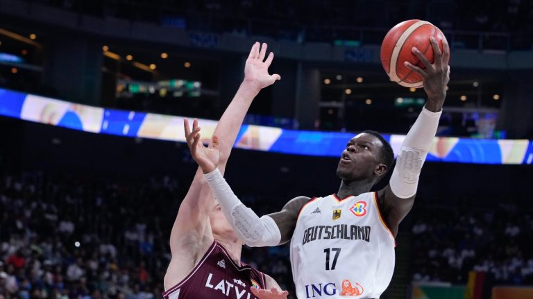 Germany guard Dennis Schroder (17) shoots for goal as Latvia forward Andrejs Gražulis (24) attempts to block during the Basketball World Cup quarterfinal between Germany and Latvia in Manila, Philippines, Wednesday, Sept. 6, 2023. (Michael Conroy/AP Photo)