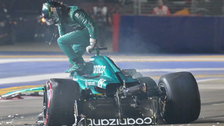 Aston Martin driver Lance Stroll of Canada goes out from his car after a crash during the qualifying session of the Singapore Formula One Grand Prix at the Marina Bay circuit, Singapore, Saturday, Sept. 16, 2023. (Caroline Chia/Pool Photo via AP)