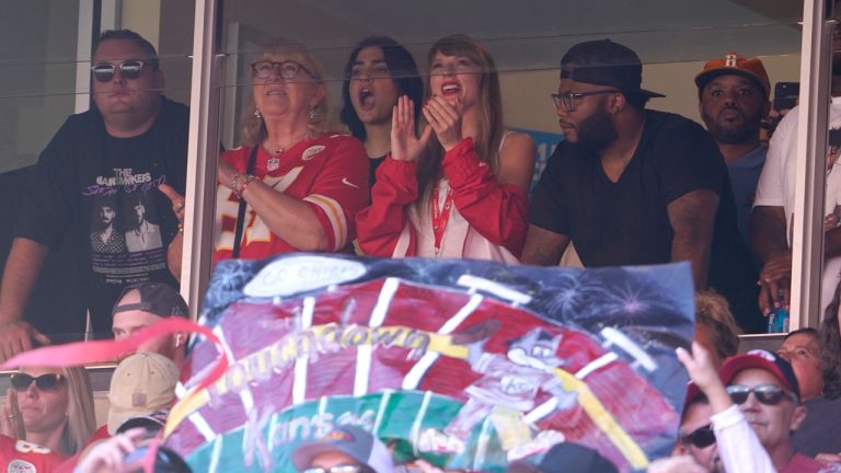 Taylor Swift watches from a suite inside Arrowhead Stadium during the first half of an NFL football game between the Chicago Bears and Kansas City Chiefs. (Ed Zurga/AP)