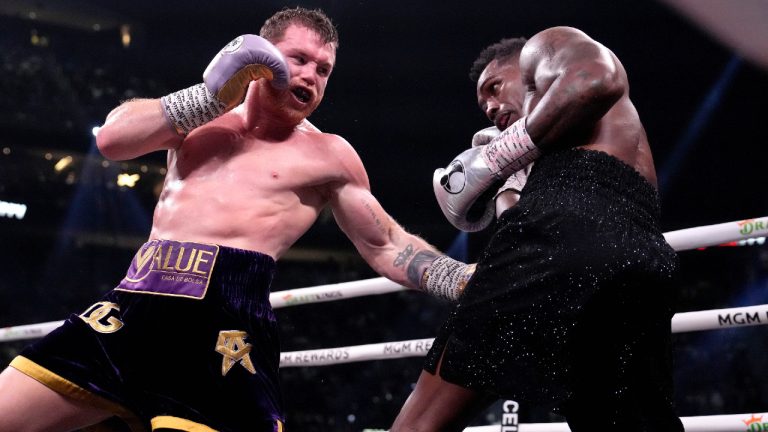 Canelo Alvarez, of Mexico, left, fights Jermell Charlo in a super middleweight title boxing match, Saturday, Sept. 30, 2023, in Las Vegas. (John Locher/AP)