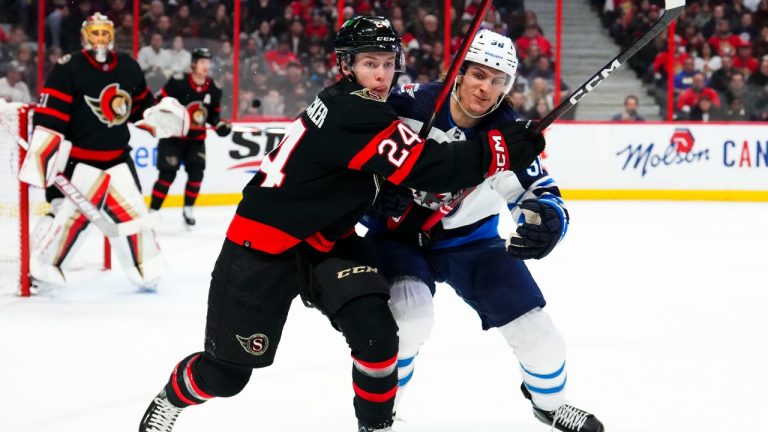 Ottawa Senators defenceman Jacob Bernard-Docker (24) and Winnipeg Jets centre Morgan Barron (36) chase the pic during first period NHL hockey action. (Sean Kilpatrick/CP)