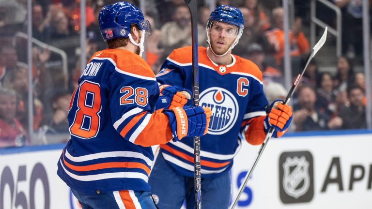 Edmonton Oilers' Connor Brown (28) and Connor McDavid (97) celebrate a goal angst the Calgary Flames during second period NHL preseason action in Edmonton on Wednesday October 4, 2023. (Jason Franson/CP)