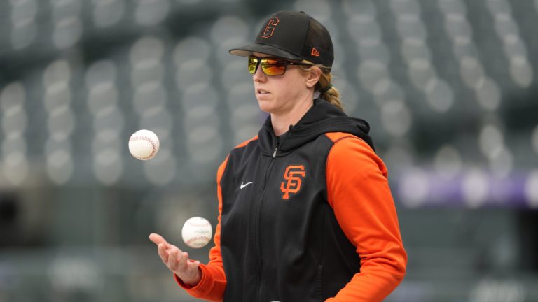 San Francisco Giants major league assistant coach Alyssa Nakken juggles baseballs as players warm up before a baseball game against the Colorado Rockies Tuesday, May 17, 2022, in Denver. (David Zalubowski/AP)