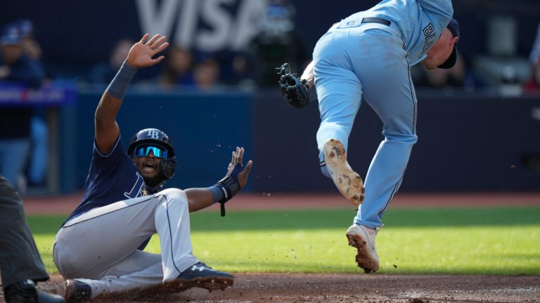 Tampa Bay Rays shortstop Junior Caminero (1) slides ahead of the tag from Toronto Blue Jays starting pitcher Wes Parsons during second inning American League MLB baseball action in Toronto, Sunday, Oct. 1 2023. Frank Gunn/CP) 