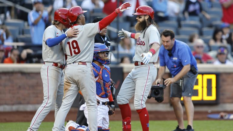 Philadelphia Phillies' Bryson Stott and Cristian Pache (19) greet Brandon Marsh, front right, at home plate after scoring on Marsh's home run against the New York Mets during the ninth inning of a baseball game, Sunday, Oct. 1, 2023, in New York. (Noah K. Murray/AP)