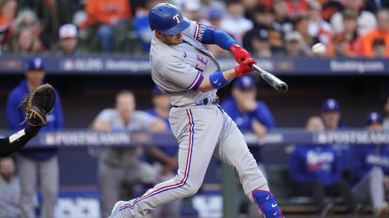 Texas Rangers' Mitch Garver hits a grand slam during the third inning in Game 2 of an American League Division Series baseball game against the Baltimore Orioles, Sunday, Oct. 8, 2023, in Baltimore. (Julio Cortez/AP)