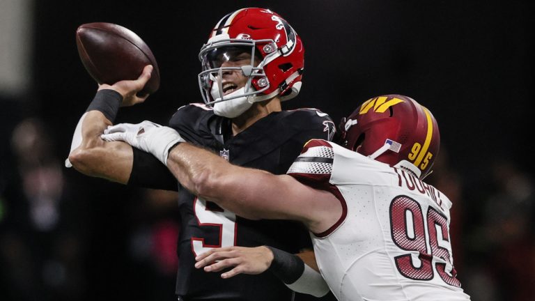 Atlanta Falcons quarterback Desmond Ridder (9) passes the ball under pressure by Washington Commanders defensive end Casey Toohill (95) during the first half of an NFL football game, Sunday, Oct. 15, 2023, in Atlanta. (Butch Dill/AP)