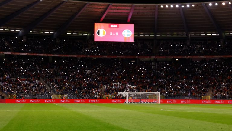 Supporters lit their mobile phones lights after suspension of the Euro 2024 group F qualifying soccer match between Belgium and Sweden at the King Baudouin Stadium in Brussels, Monday, Oct. 16, 2023. Two Swedes were killed in a shooting late Monday in central Brussels, police said. (Geert Vanden Wijngaert/AP) 