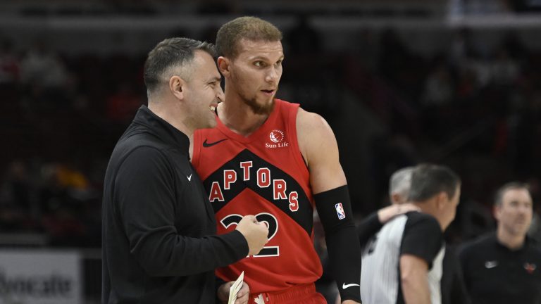 Toronto Raptors head coach Darko Rajakovic talks with guard Malachi Flynn (22) during the second half of a pre-season NBA basketball game against the Chicago Bulls, Tuesday, Oct. 17, 2023, in Chicago. (AP Photo/Matt Marton)