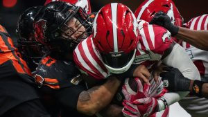 B.C. Lions' Sione Teuhema, left, tackles a Calgary Stampeders' player during the first half of a CFL football game, in Vancouver, on Friday, October 20, 2023. (Darryl Dyck/CP)