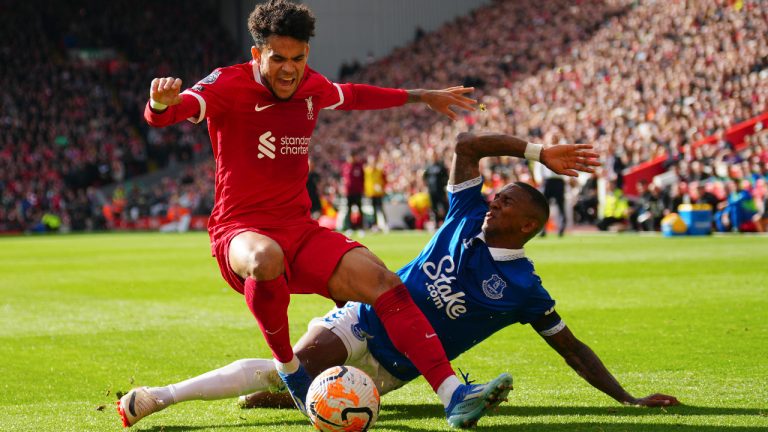 Liverpool's Luis Diaz, left, challenges for the ball with Everton's Ashley Young during the English Premier League soccer match between Liverpool and Everton, at Anfield in Liverpool, England, Saturday, Oct. 21, 2023. (Jon Super/AP) 