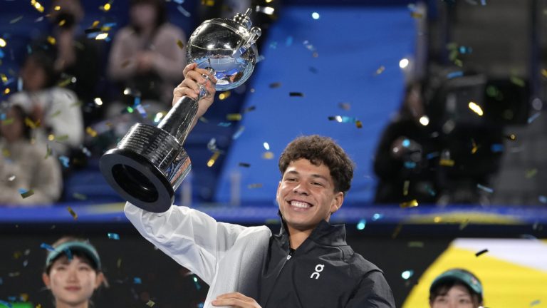 Ben Shelton of the U.S. holds the winning trophy aloft after defeating Aslan Karatsev of Russia in the men's singles final of Japan Open tennis championships in Tokyo, Japan, Sunday, Oct. 22, 2023.(Shuji Kajiyama/AP)