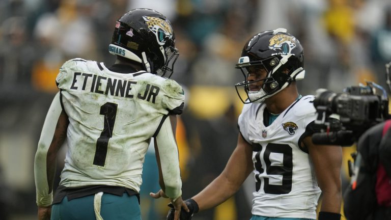 Jacksonville Jaguars running back Travis Etienne Jr. (1) celebrates his touchdown against the Pittsburgh Steelers with wide receiver Jamal Agnew (39) during the second half of an NFL football game Sunday, Oct. 29, 2023, in Pittsburgh. (Gene J. Puskar/AP)