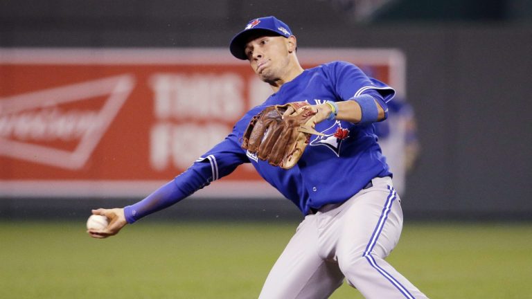 Toronto Blue Jays second baseman Ryan Goins throws Kansas City Royals' Alex Gordon out at first during the seventh inning in Game 6 of baseball's American League Championship Series on Friday, Oct. 23, 2015, in Kansas City, Mo. (Charlie Riedel/AP)