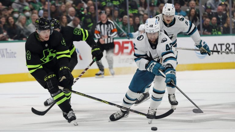 Dallas Stars defenceman Miro Heiskanen (4) and San Jose Sharks left wing Jonah Gadjovich (42) fight for the puck during the second period of an NHL hockey game in Dallas, Saturday, Dec. 31, 2022. (Michael Ainsworth/AP)