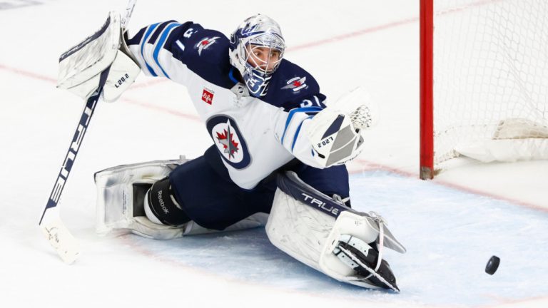 Winnipeg Jets goaltender Connor Hellebuyck (37) makes a glove-save during the third period of an NHL hockey game against the Buffalo Sabres, Thursday, Jan. 12, 2023, in Buffalo, N.Y. (AP Photo/Jeffrey T. Barnes) 