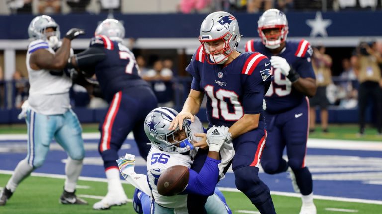 Dallas Cowboys defensive end Dante Fowler Jr. (56) strips the ball away from New England Patriots quarterback Mac Jones (10) in the first half of an NFL football game. (Michael Ainsworth/AP)