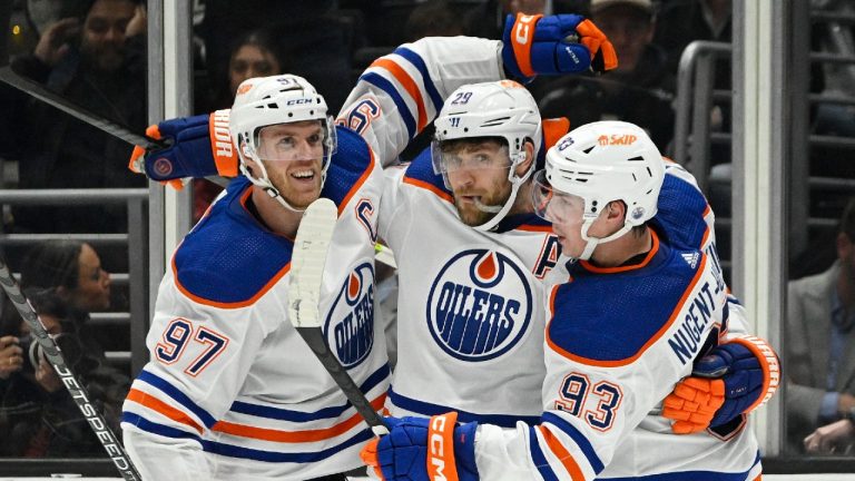 Edmonton Oilers center Leon Draisaitl, center, celebrates his goal with center Connor McDavid, left, and center Ryan Nugent-Hopkins during the second period of an NHL hockey game Tuesday, April 4, 2023, in Los Angeles. (Mark J. Terrill/AP)