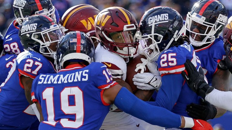 Washington Commanders running back Antonio Gibson is tackled by the New York Giants during the third quarter of an NFL football game, Sunday, Oct. 22, 2023, in East Rutherford, N.J. (Adam Hunger/AP Photo)