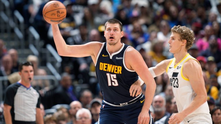 Denver Nuggets center Nikola Jokic, left, fields a pass as Utah Jazz forward Lauri Markkanen defends in the second half of an NBA basketball game, Monday, Oct. 30, 2023, in Denver. (David Zalubowski/AP)